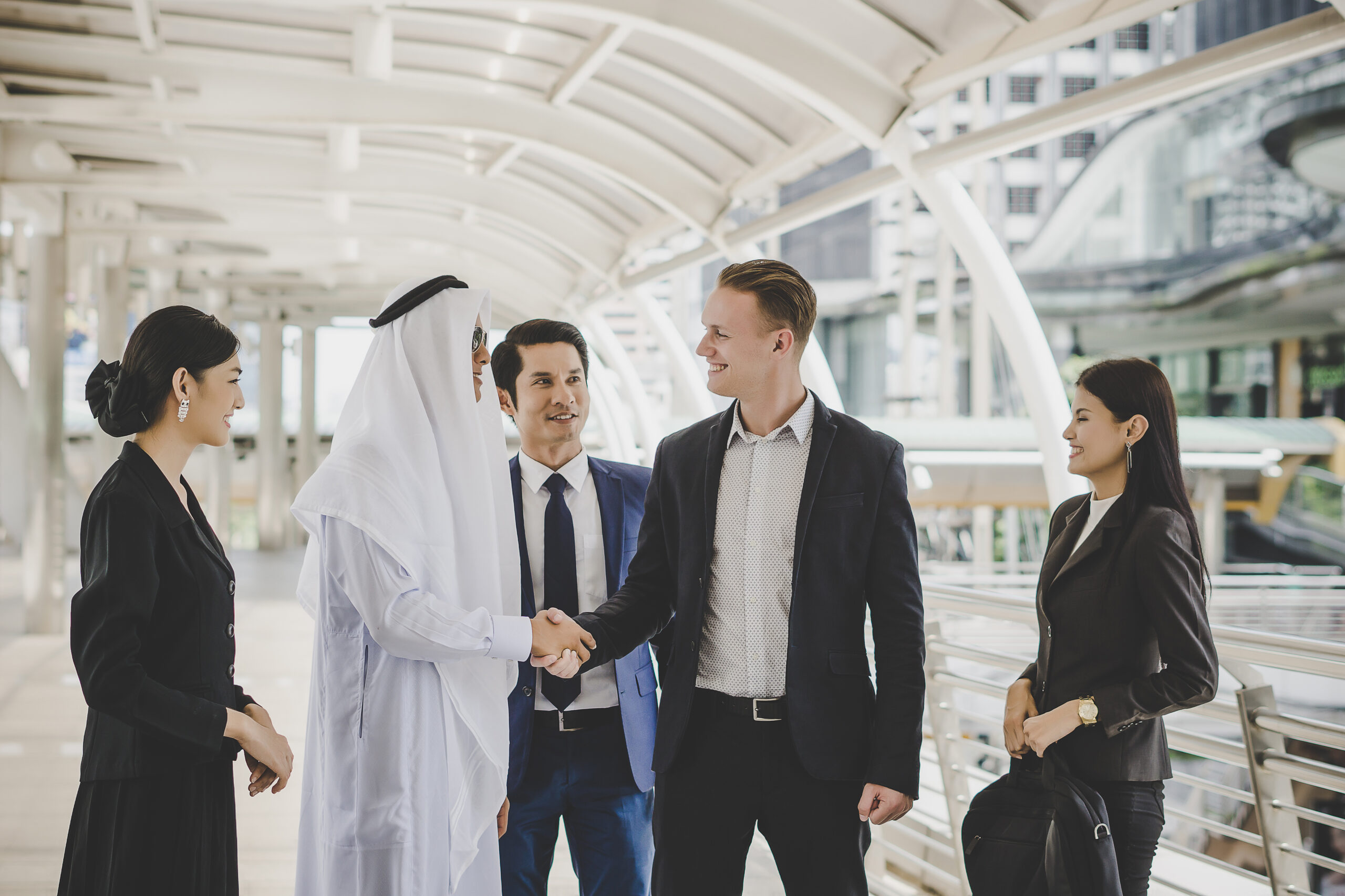 Portrait of business partners greeting one another by handshakin